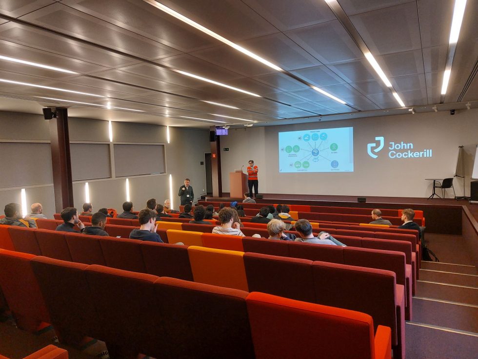 group of students in an auditorium listening experts
